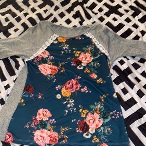 selling a floral long sleeve conditions are okay besides one rip at the top